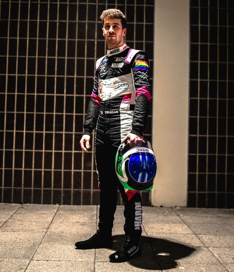 Daniel Truman in his race suit, holding his helmet