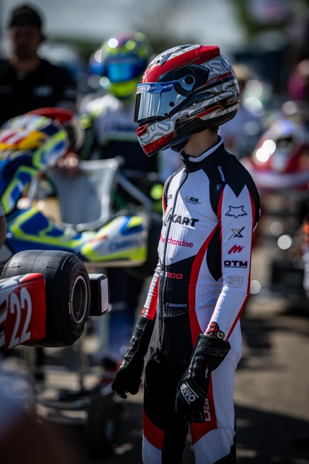 Zak standing by his number 22 Super One kart