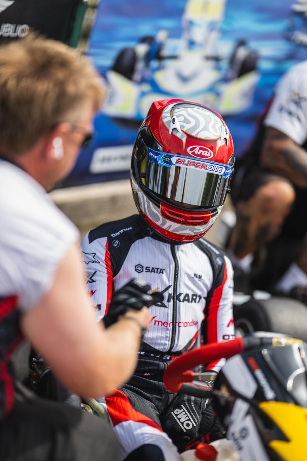 Zak sat in his kart with a mechanic on the Super One dummy grid