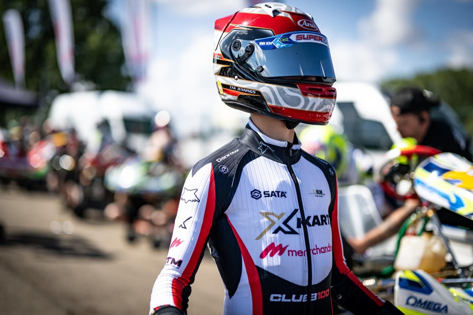 Zak in his helmet and Super One race suit in the paddock